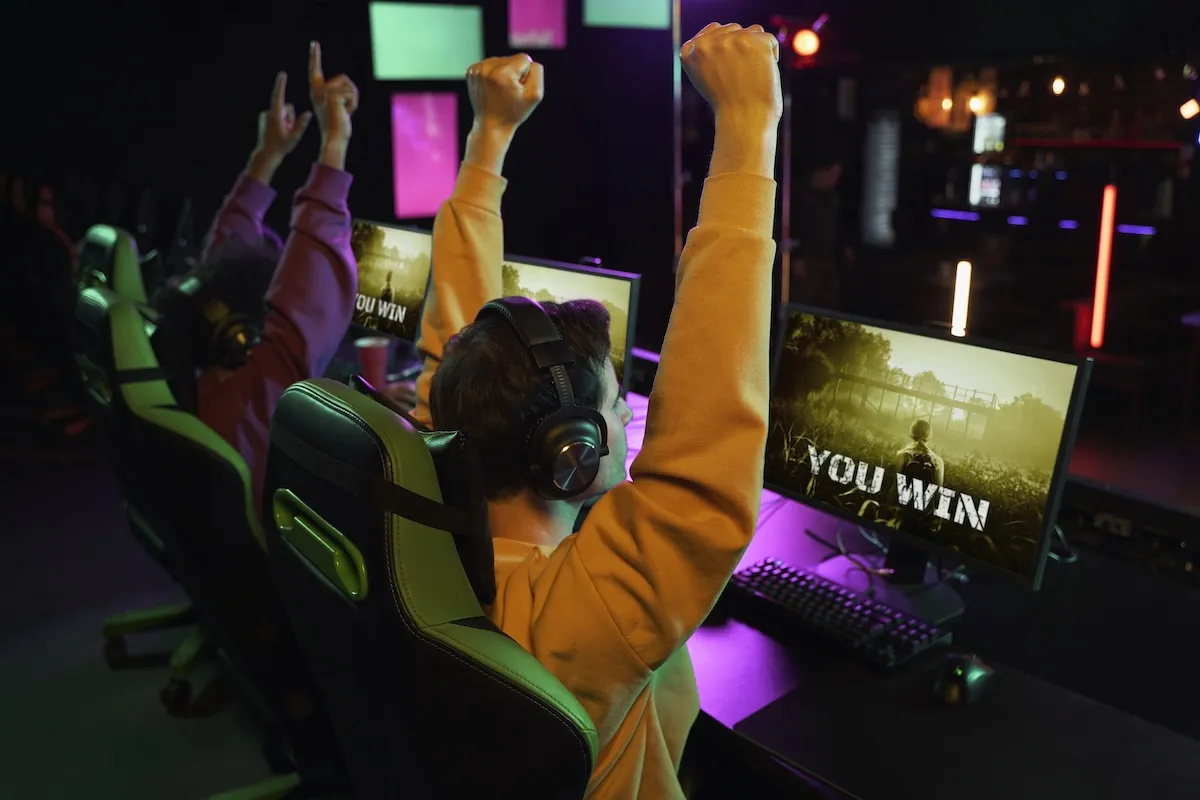 medium-shot-victorious-gamers-winning