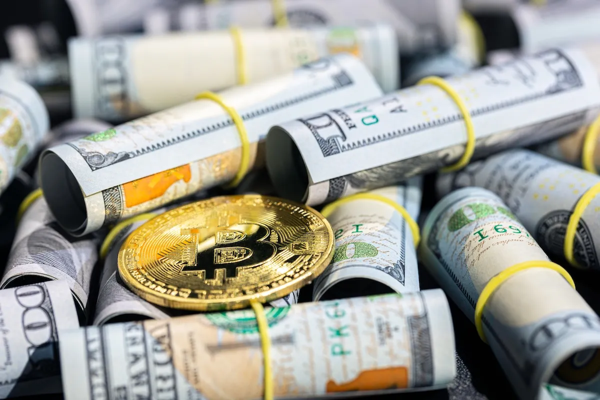 bitcoin-coin-with-100-dollar-bill-concept-finance-background-closeup