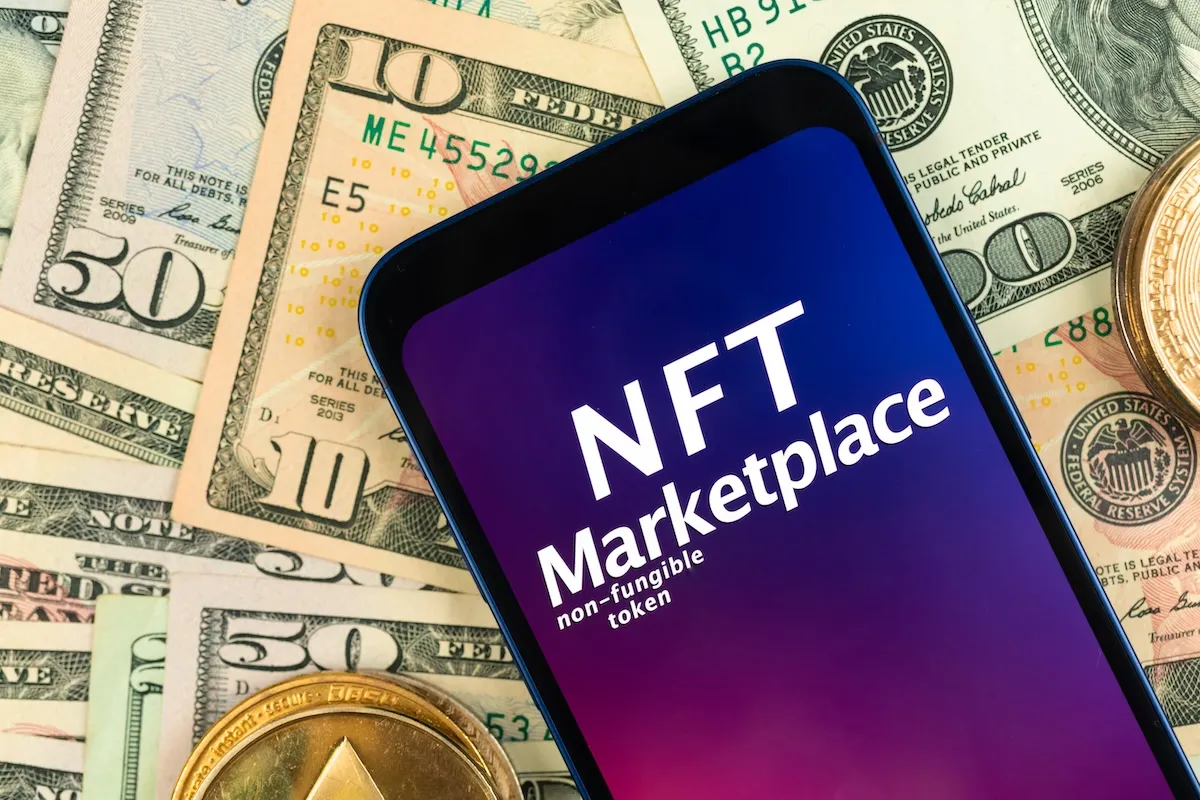 nft-cryptoart-marketplace-background-smartphone-with-nft-application-money-background-with-golden-crypto-currency-coins-top-view-photo